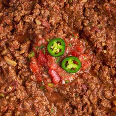 chili and peppers are mixed together in a dish