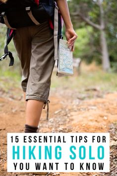 a hiker with a map and backpack walking down a trail