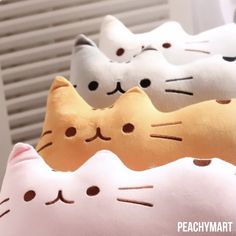 three pillows with cats on them sitting next to each other