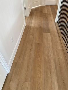 Hallway using Citadel by Paradigm, showing off deep brown, gold and subtle orange accents for a rich natural oak that doesn't feel heavily traditional. Paradigm Conquest Flooring, Blonde Laminate Flooring, Blonde Wood Floors, Blonde Flooring, Modern English Country, Maple Floors, Lvp Flooring, Waterproof Flooring