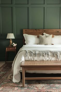 a bedroom with green walls and white bedding