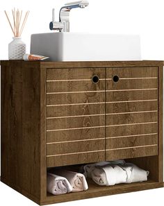 a wooden cabinet with two drawers and a sink in the middle, next to some folded towels