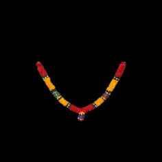 a beaded necklace is shown against a black background in this image the beads are red, yellow and green