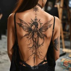 the back of a woman's body with tattoos on her upper and lower back