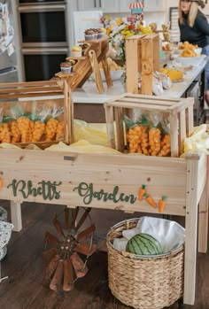 a wooden cart filled with lots of food on top of a kitchen counter next to a woman