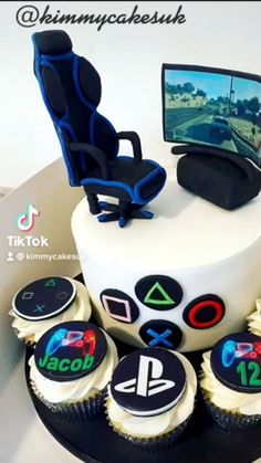 a birthday cake decorated with video games and cupcakes