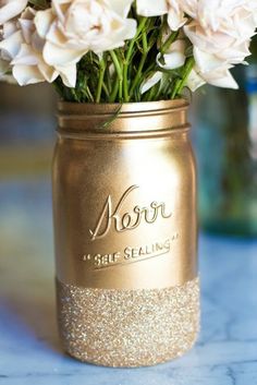 a gold mason jar with glittered mason jars on it's side and the words glitter dipped mason jars below