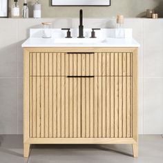 a bathroom vanity with two sinks and a mirror on the wall above it in a neutral color scheme