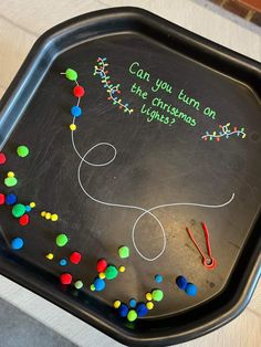 a black tray with writing on it that says can you turn on the christmas lights?