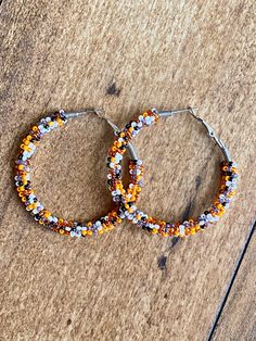 A pair of hoop earrings made with limited edition seed beads in unique whites, oranges, black and aura gray! Comes in 3 sizes! 30mm (1 inch) 40mm (1.5 inch) 50mm (2 inch) These are made from a VERY limited mix so get them while you can! These one of a kind earrings are fantastic for raves, night clubs, parties, summer vacations, festivals or just for a pop of color in your wardrobe.  Made with a spring clasp for ease. Hypoallergenic professional grade metals, none of the cheap stuff used here! W Cheap Stuff, Boho Hoop Earrings, Night Clubs, Summer Vacations, Tiger Stripes, Jewelry Earrings Hoops, Something Else, Send Me A Message, Night Club