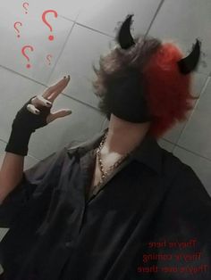 a woman with red hair and devil horns on her head