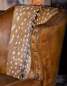 a brown leather chair with white spots on it