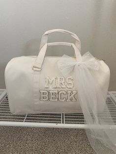 "Duffle Bag Personalization available select \"CUSTOM\" option to personalize your bag with your name or phrase.  Letter Options: Varsity patch Letters  A-Z no numbers, symbols or shapes are available. returns and exchanges are not accepted however please reach out if you have an issue with your order" Personalized White Bag For Wedding Gift, Bride Travel Bag, Honeymoon Bag, Bride Era, Patch Letters, Wedding Fayre, Numbers Symbols, Bride Bag, Wedding Hands