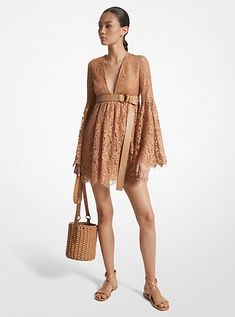 Capture the essence of ‘60s-inspired dressing in this floral lace mini dress, which debuted on the Spring/Summer 2024 runway. Dramatic bell sleeves, an empire waist and a plunging neckline combine to create an ultra-feminine silhouette. Lean into the bohemian aesthetic with dainty sandals and a bucket bag to complete the look. Dainty Sandals, 2024 Runway, Bohemian Aesthetic, Ultra Feminine, Runway Dresses, Empire Dress, Feminine Silhouette, The Bohemian, Spring Summer 2024