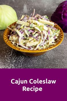 cabbage coleslaw in a wooden bowl next to an onion on a table with the title cajun coleslaw recipe