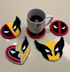 coffee cup and coasters made to look like deadpool