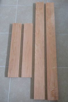 three pieces of wood laying on the floor