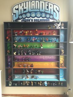 a display case filled with lots of toy figurines on top of wooden shelves