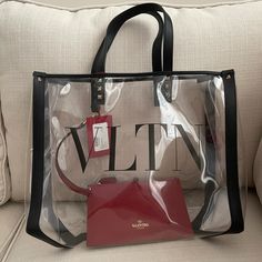 Valentino Garavani Small Grand Plage Clear Pvc Tote With Black Leather Trim And Signature Rockstuds. Comes With Removable Red Leather Pouch. Signature Abbreviated Vltn Logo Measures 14 3/4”W X 11 1/2”H X 6”D Open Top With Carry Handles Comes With Original Dust Bag And Cards Designer Black Bags For Vacation, Designer Black Bags For Summer, Trapeze Bag, Large Hobo Bag, Valentino Garavani Bag, Rose Bag, Patent Leather Bag, Brown Tote, Small Tote