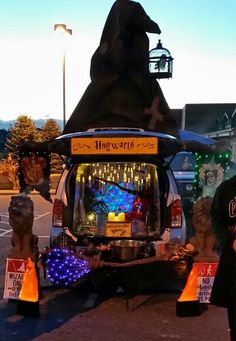 a man standing next to a vehicle decorated with lights