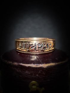 "Charming and intricately detailed antique 'Mizpah' ring crafted in buttery 9ct rose gold, the lettering vividly stands out over a sleek background Throughout the Victorian era, the process of engraving rings with the word \"MIZPAH\" was adored and lovingly gifted between two sweethearts.  'Mizpah' which is Hebrew for watchtower signifies an emotional bond between two people. The meaning of the word is loosely interpreted as \"May God watch over you,\" it is with the intention that the piece is to be gifted as a token of  love or friendship. The rosy coloured band is sleek allowing for the bold ''Mizpah'' letters to really stand out from its background and a textured design borders the rings edge, the ring has crisp antique hallmarks which are an added bonus The original purpose of this be Engraving Rings, Gold C, Ring Crafts, Textured Design, Multi Stone Ring, Multi Stone, Engraved Rings, The Meaning, Victorian Era