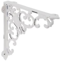 a white shelf bracket with ornate designs on it