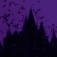 a flock of birds flying in front of a castle at night with purple sky behind it