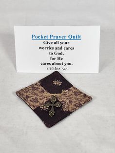 a small card with a cross on it and a message about the pocket prayer quilt