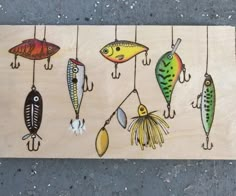 a wooden board with different types of fish hanging from hooks