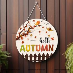 a wooden sign that says hello autumn hanging on a wall