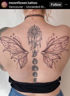 the back of a woman's upper body with tattoos on her chest and wings