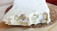 a piece of food sitting on top of a wooden cutting board