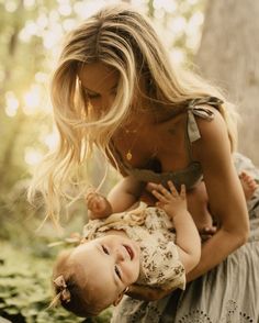 a woman holding a baby in her arms