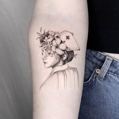 a woman with a hat and flowers on her head is shown in this tattoo design