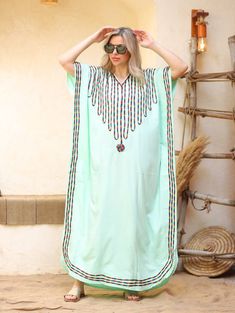 An elegant and stylish caftan will make you feel like African royalty. It's extremely elegant with a dash of colorful cotton embroidery adorning the kaftan. Ideal for plus size women as well. Made of extremely soft fabric to make you feel free and beautiful at the same time.  This Kaftan is ideal to wear for any casual occasion. Whether taking a trip down the shopping lane, or home-based kitty parties, or about anything else, wearing this dress will make you feel classy and comfortable. Fabric : Green Long Kaftan For Festival, Long Green Kaftan For Festival, Green Kaftan For Vacation And Eid, Bohemian Green V-neck Abaya, Green Kaftan For Eid Vacation, Green Free Size Festival Kaftan, Green Long Thobe For Beach, Green Embroidered V-neck Kaftan, Traditional Green Free Size Kaftan