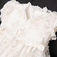 Handmade in the USA This girls Baptism gown is so gorgeous and so detailed, it's not a stretch to say that it is truly a work of art. The lace overlay on this baptism gown is both stunning and special, made of embroidered netting with a rich floral design featuring embroidered flowers in a pretty shade of ivory with champagne cording, adding depth and richness. Trimmed in ivory Venice edging and long ivory or pink silk ribbon bows flowing down the skirt. Includes the matching lace bonnet. This b Pink Silk Ribbon, Baptism Gown Girl, Lace Bonnet, Lace Coat, Baptism Gown, Christening Gown, Baptism Girl, Most Beautiful Dresses