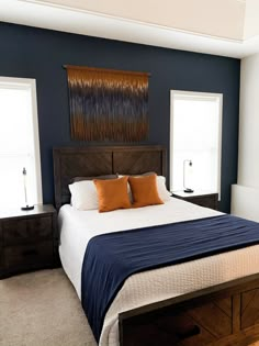 a bedroom with blue walls and white bedding