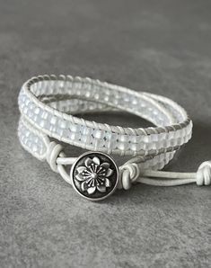 "Made of beautiful beading, this wrap bracelet is designed to wrap 2 times around most wrists. Hand sewn with heavy duty white thread on matching pearlescent white leather cord using frosted white Czech glass seed beads. Closure using an artisan flower antiqued pewter metal button with three loop adjustments for inclusive sizing. Bracelet measures approx. 14 inches and sizing loops adjust approx. 14 1/2\" - 16 1/2\" and fits an average 6 1/2 - 7 inch wrist. **Please message me for custom sizing Adjustable White Spiritual Wrap Bracelet, White Adjustable Spiritual Wrap Bracelet, Handmade Adjustable White Leather Bracelet, White Handmade Adjustable Leather Bracelet, Adjustable Handmade White Leather Bracelet, Handmade White Leather Adjustable Bracelet, Sharp Scissors, Flower Button, Pewter Metal