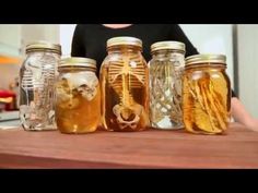 the jars are filled with different types of honey and skeleton carvings on them, as if they were human remains