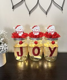 three jars filled with candy sitting on top of a table