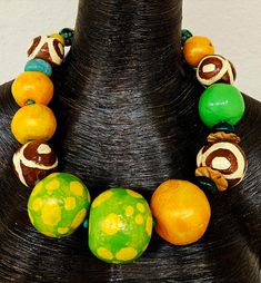 Even though this is a new listing, I am placing it in the FINAL SALE collection since I am not entirely pleased with the way the paint behaved on this piece. Large and oversized hand sculpted beads are painted in a variety of colors: orange with a color shift glaze, green and yellow polka dot with a color shift glaze, lime green, African batik patterned beads, agate, coconut, resin and African glass. Most beads are separated with tiny turquoise spacers. The sculpted beads are sealed with a satin Colorful Large Beaded Necklaces, Artistic Green Necklace For Festivals, Green Wooden Beads Jewelry For Festival, Unique Green Wooden Beads, Green Wooden Beaded Necklaces, Unique Green Wooden Beaded Necklaces, Unique Green Necklaces With Wooden Beads, Green Wooden Beads Necklaces For Festivals, Artisan Green Hand Painted Necklaces