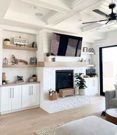 a living room filled with furniture and a flat screen tv mounted on the wall above a fireplace