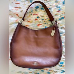 Coach Saddle Brown Nomad Burnished Leather Hobo Bag. Well Loved With Some Signs Of Wear. Sorry, Unable To Locate Additional Long Crossbody Strap. Coach Shoulder Bag With Leather Lining For Shopping, Coach Leather Bag For Errands, Coach Rectangular Soft Leather Hobo Bag, Coach Hobo Shoulder Bag With Leather Handles, Coach Hobo Bag With Leather Handles For Daily Use, Coach Leather Handheld Shoulder Bag, Classic Coach Hobo Bag With Handle Drop, Everyday Coach Hobo Bag With Handle Drop, Daily Use Coach Hobo Bag With Handle Drop