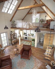 an overhead view of a living room and bedroom area in a loft with wood flooring