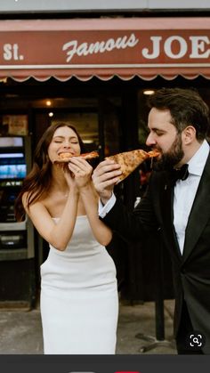 a man and woman eating pizza in front of a restaurant