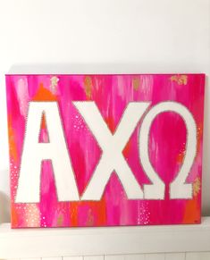 a pink and white painted sign with the letters q and ax on it's side