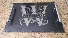 a black slate coaster with the words williams on it