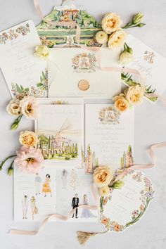 the wedding stationery is laid out on top of each other with flowers and ribbons