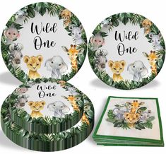 three plates with animals on them and the words wild one written in black ink, surrounded by greenery