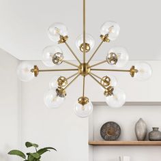 a modern chandelier with glass globes hanging from the ceiling